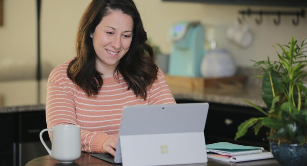Smiling woman with her laptop