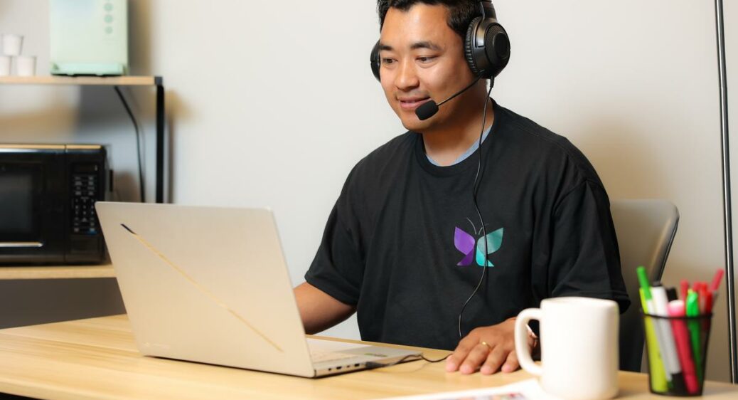 Direct Support Professional staff at Louisa Ridge sitting at a desk with a laptop