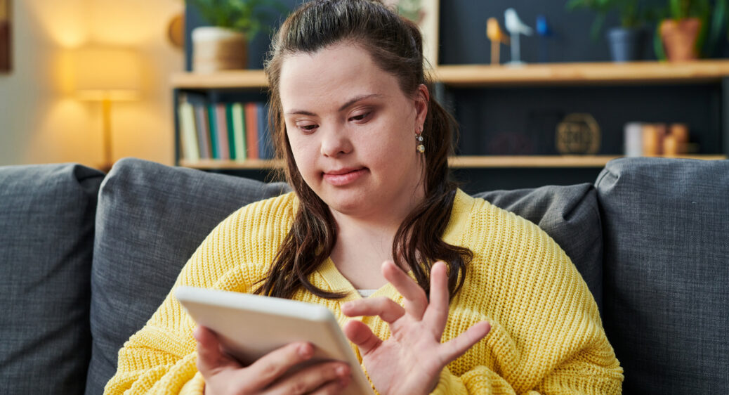 Young Woman With Down Syndrome Using Tablet