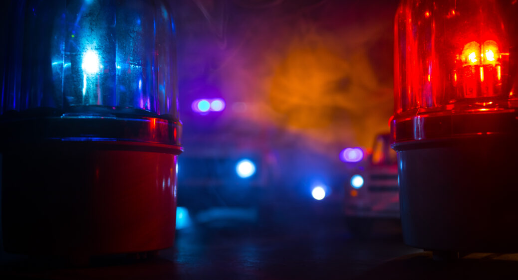 Photo of police car blue and red round vintage siren in dark.