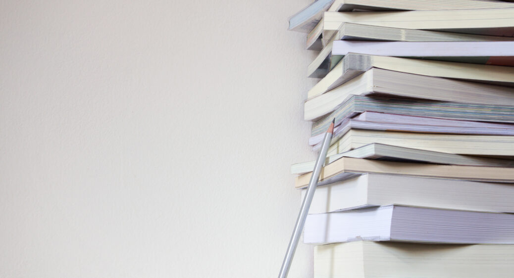 Close up book stacked with concrete wall background
