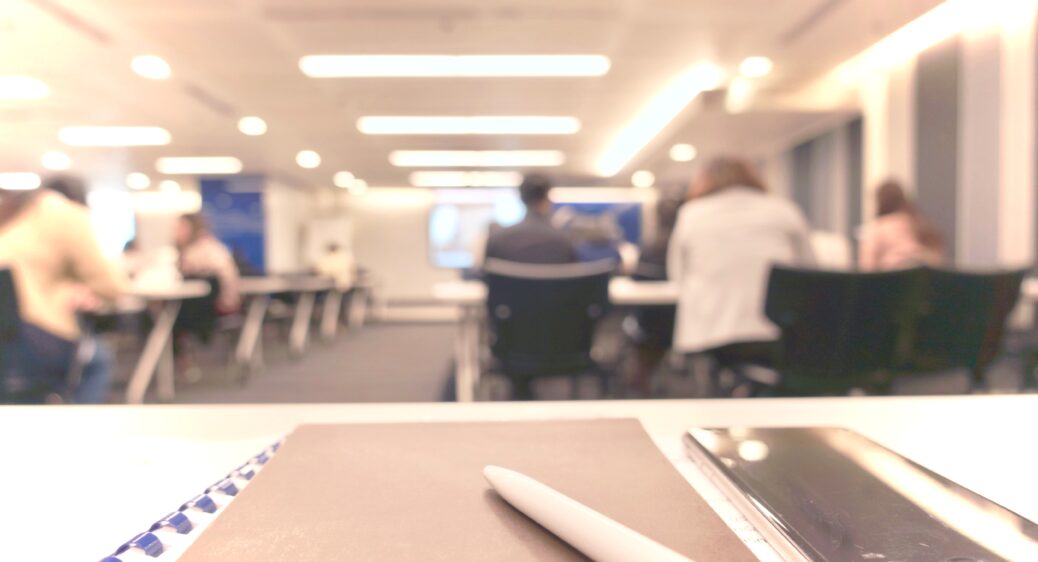 Abstract defocused photo of conference room with attendees background.